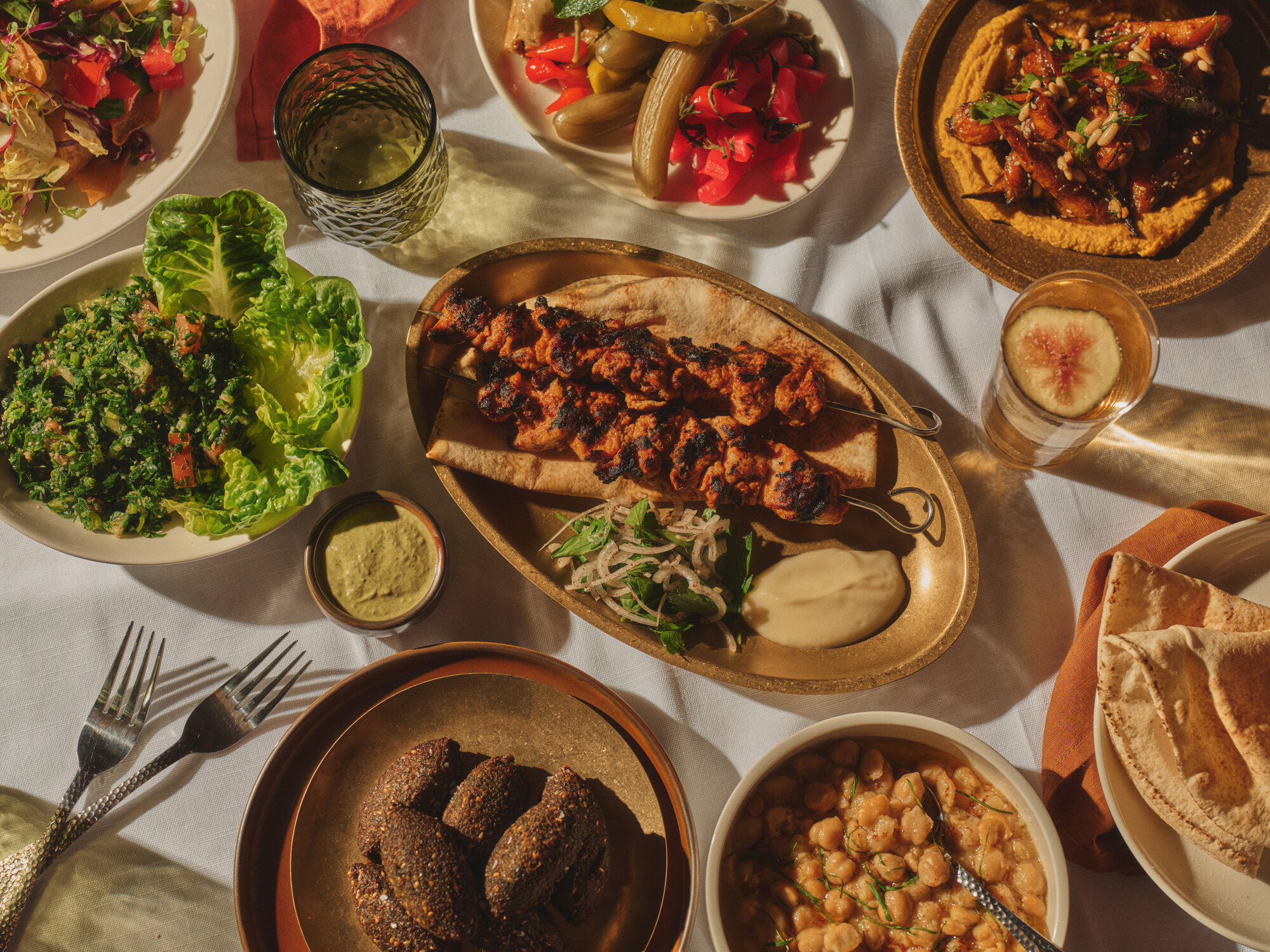 Sahtein shared Lebanese plates with skewers, mezze, bread and salads